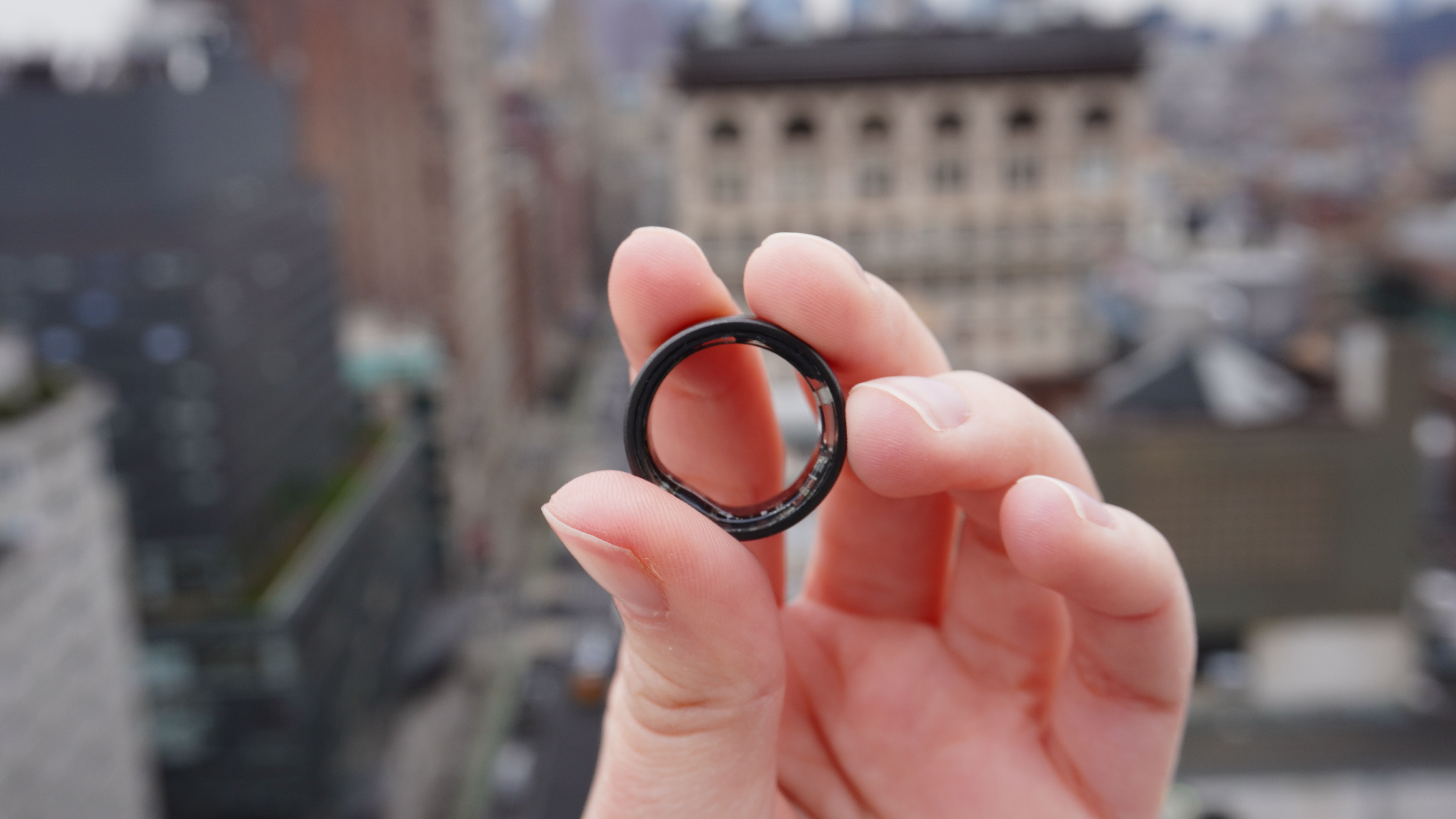 Ultrahuman Ring Air being held in a hand